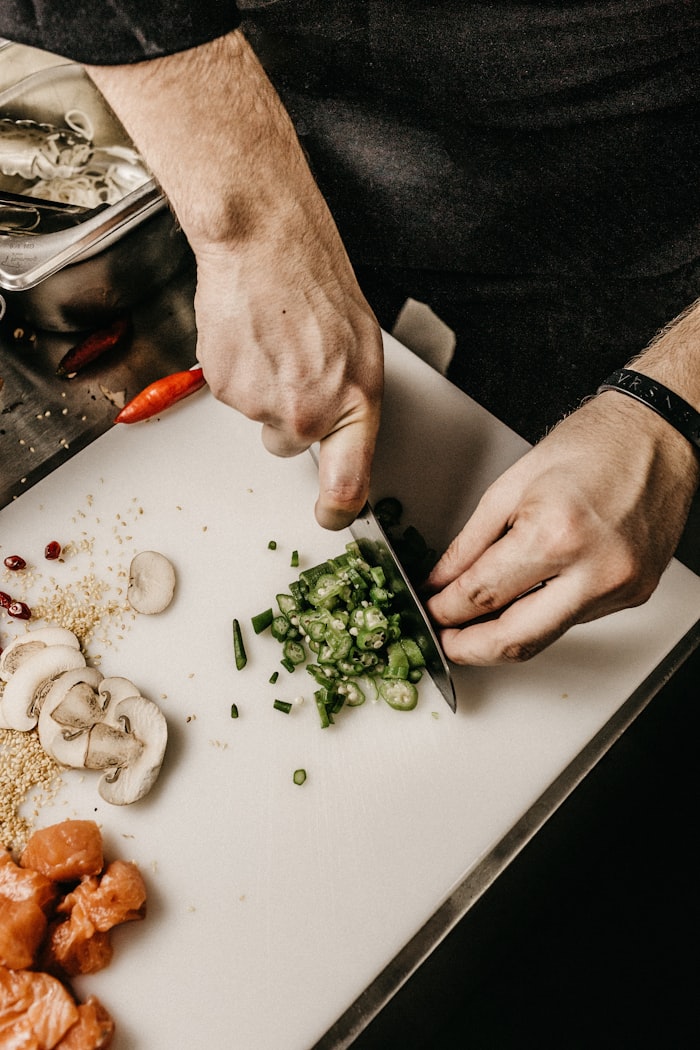 A cook finishing a dish in the Dhunki kitchen